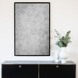 Akustikbild "Shade" der Serie Magnitudo mit dunklem Vollholzrahmen und grauem, abstraktem Fotomotiv in Hochformat und Frontansicht