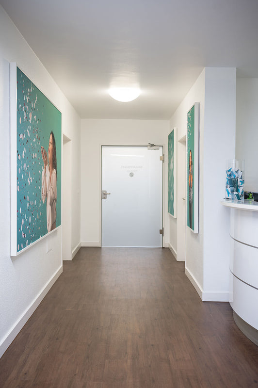 picture of a room with beautiful white door and side by there are three picture of acoustic art work